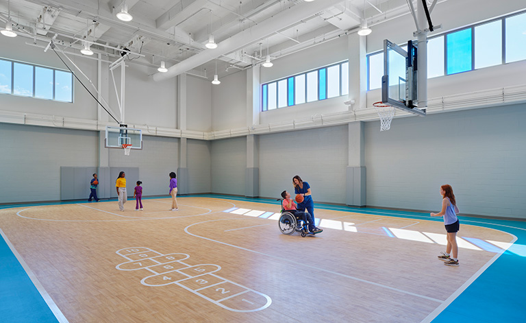 A variety of shared spaces, like the gym, create destinations within the building.