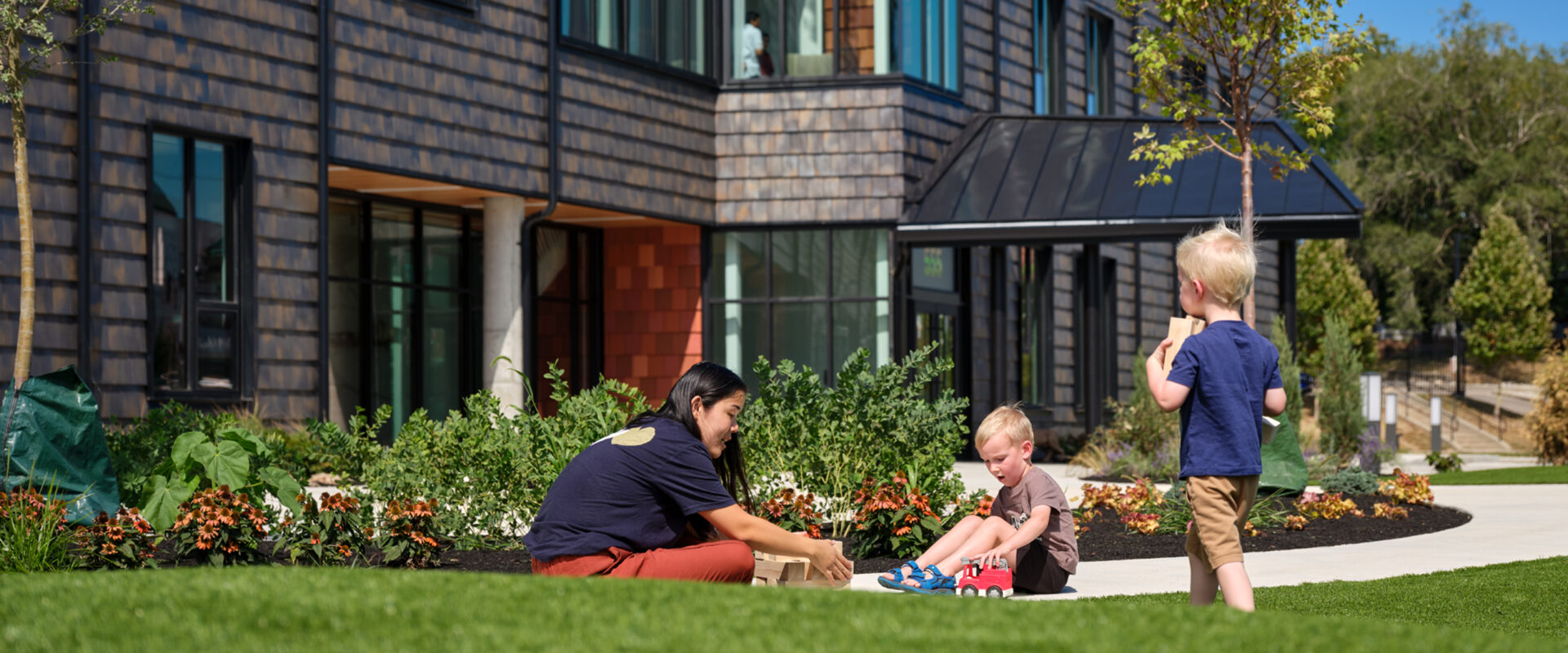 Adult and kids play on lawn