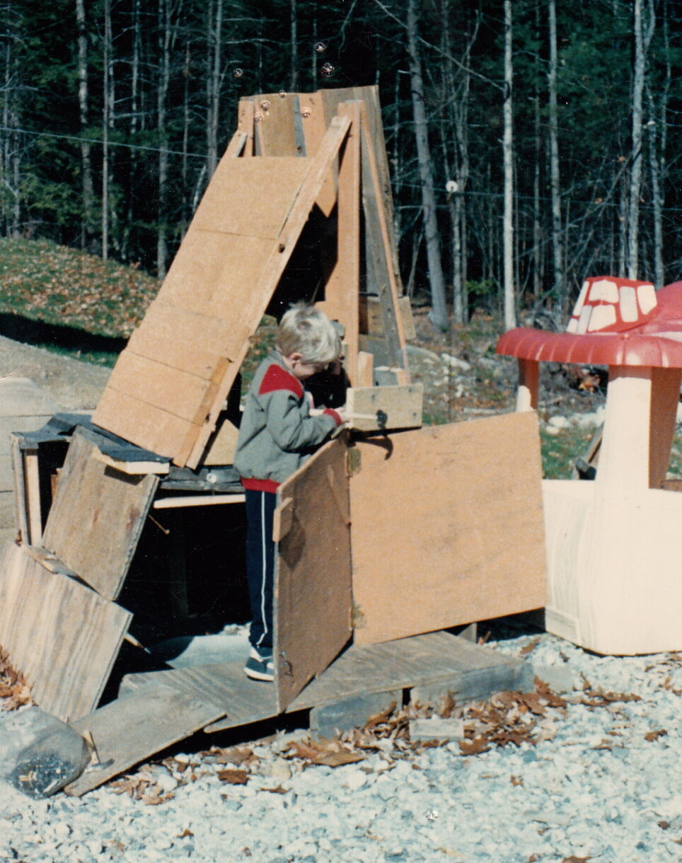 kids playhouse built out of cardboard and scrap pieces - outside. old picture